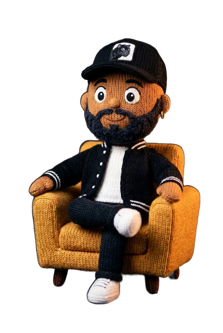 A knitted designer-toy version of Antwon Ward, sitting in a gold armchair